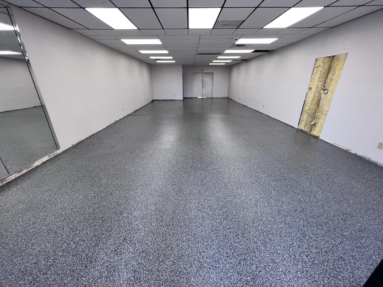 Gray and black resinous flake epoxy floor across a Phoenix commercial retail space