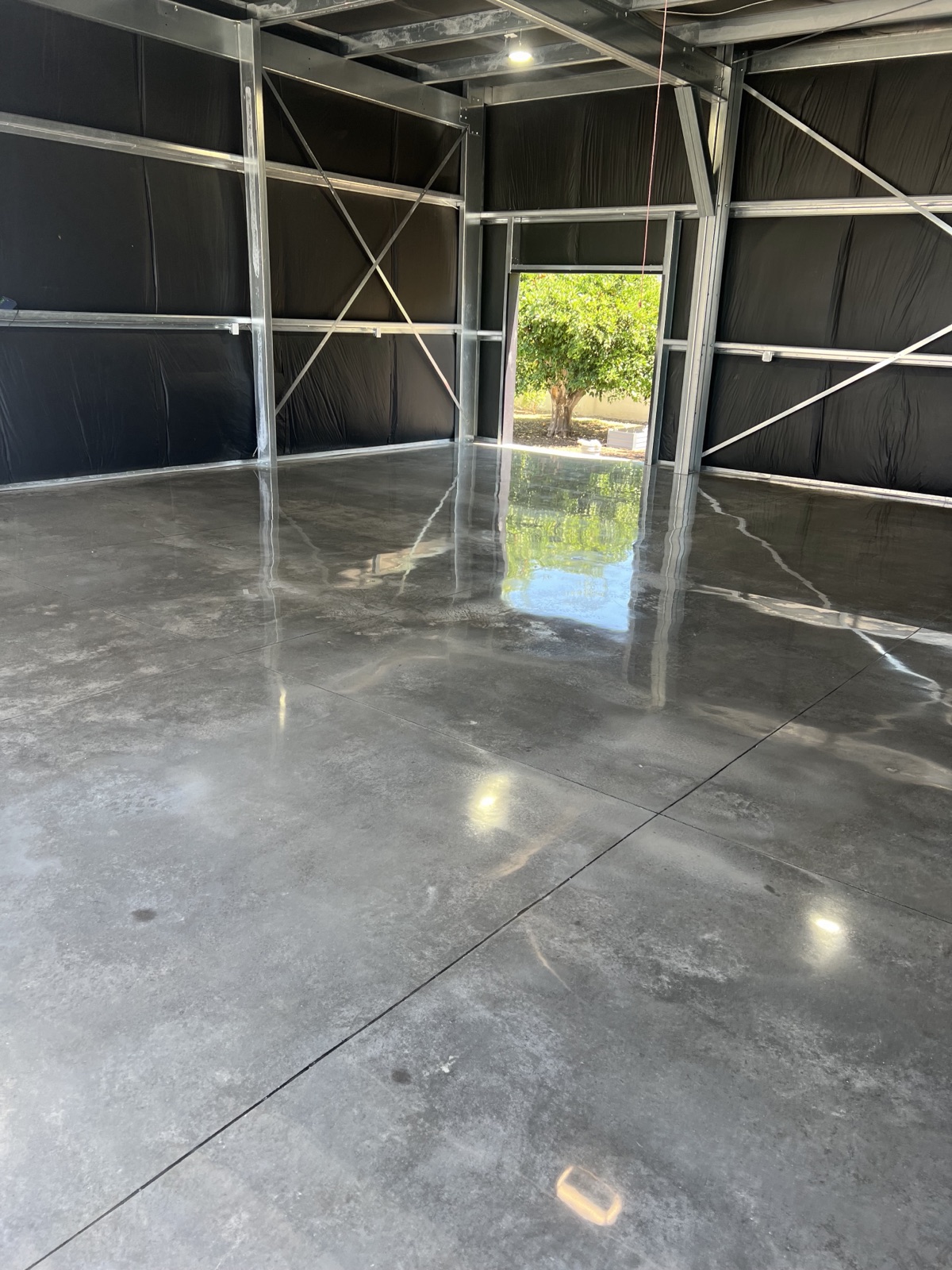Charcoal high-gloss polished concrete floor in a new Phoenix steel-frame building