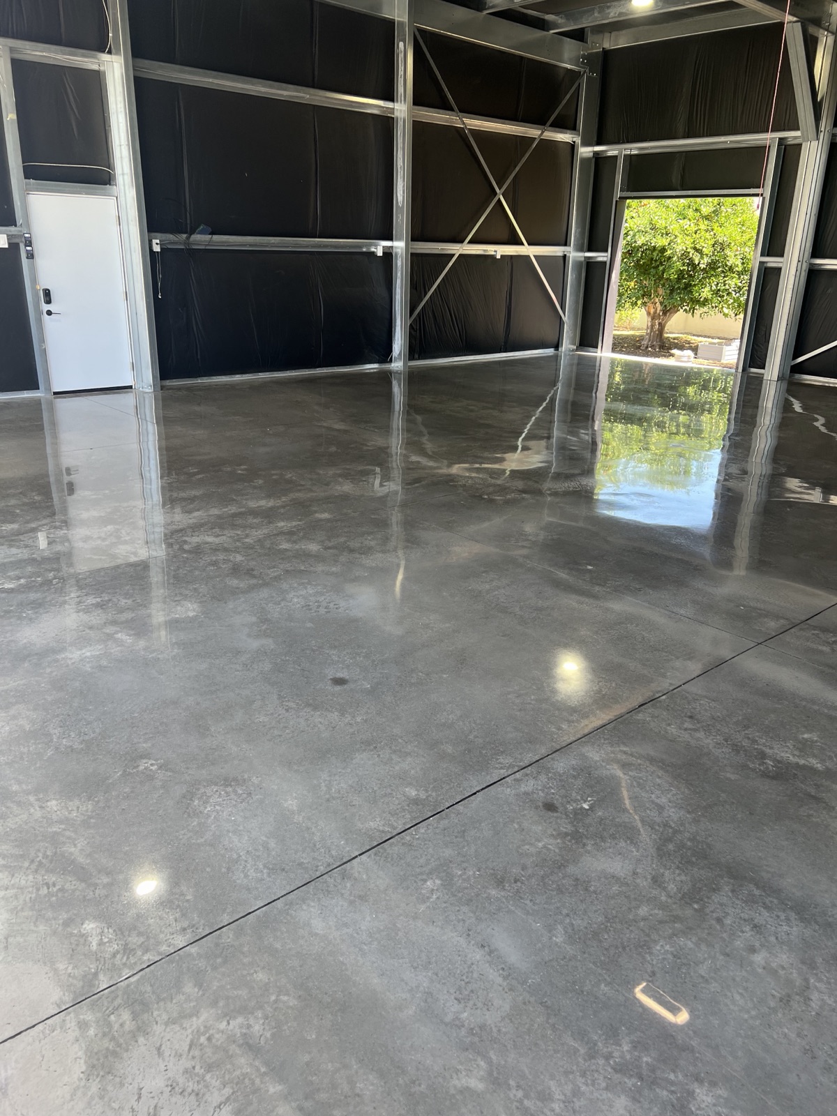 Charcoal high-gloss polished concrete floor in a new Phoenix steel-frame building