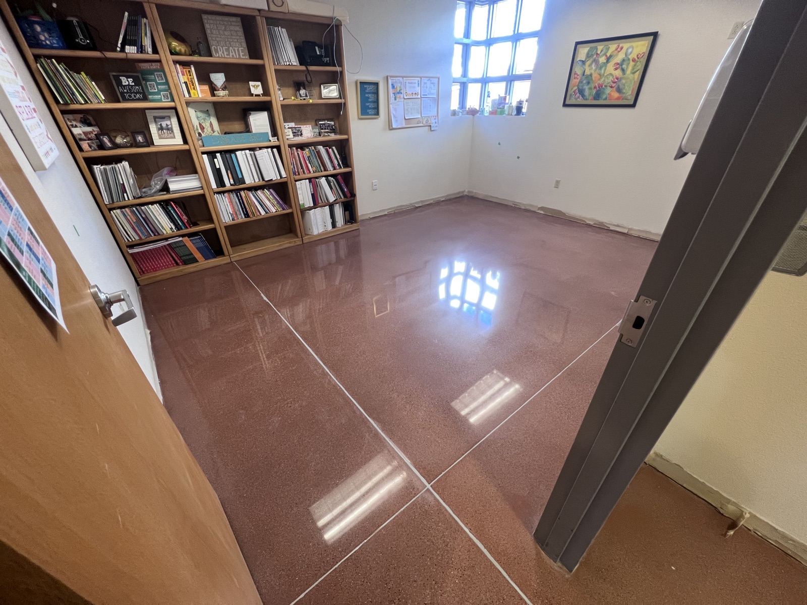 Polished concrete floor in a classroom with bookshelves