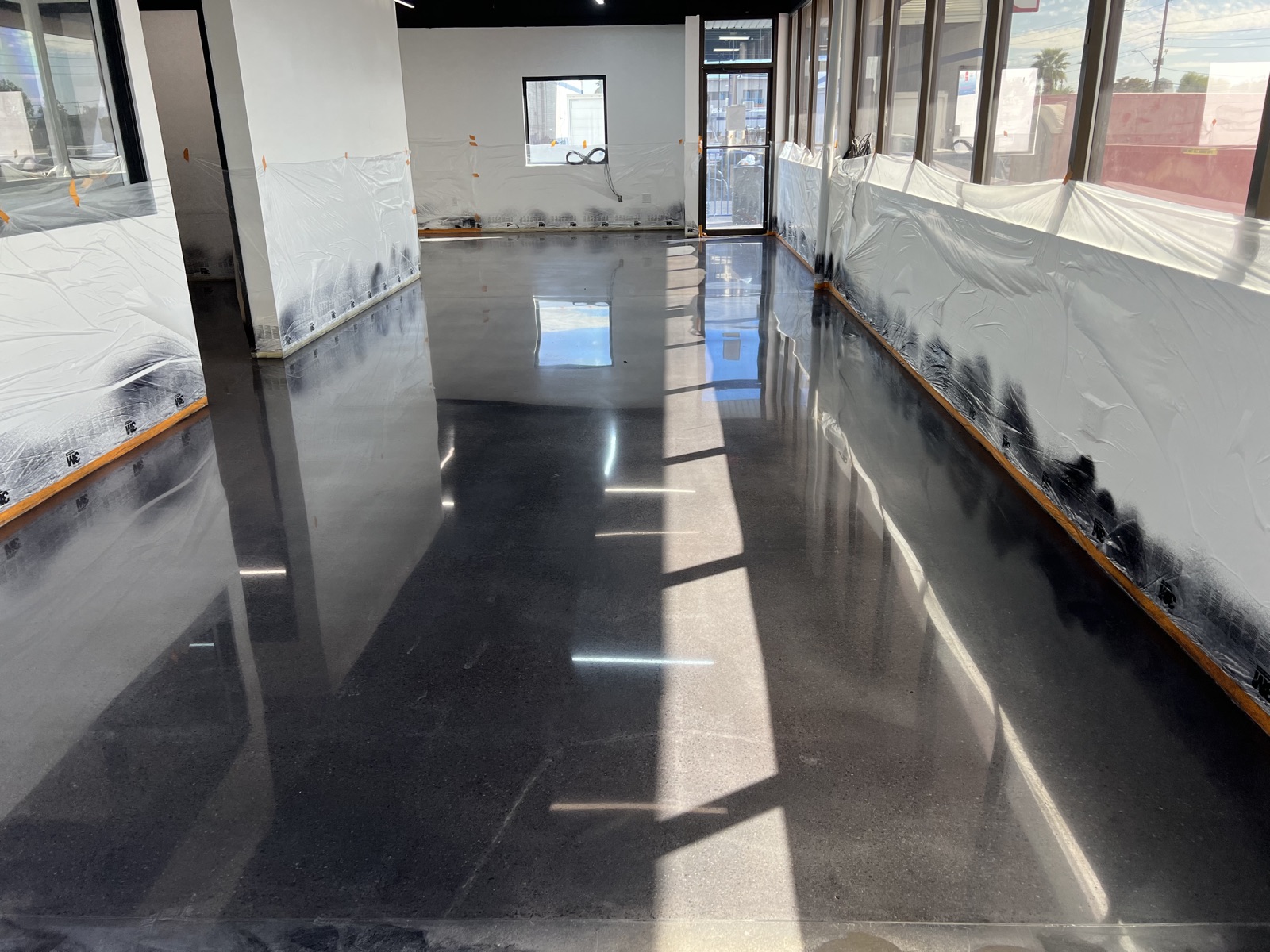 High-gloss dark polished concrete floor in a Phoenix retail buildout